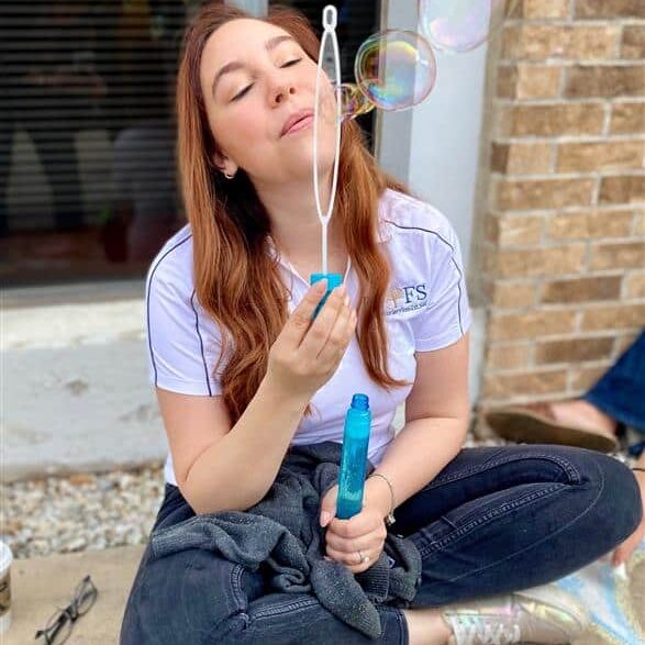 ConnectED staff member blowing bubbles during an event